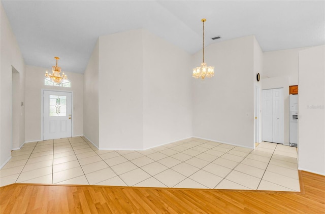9519 Scenic Pine Ct, New Port Richey, FL 34655 - entrance foyer with a chandelier and light wood-style flooring