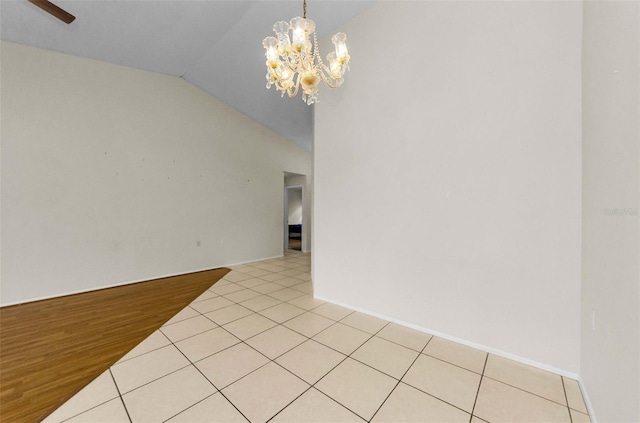 9519 Scenic Pine Ct, New Port Richey, FL 34655 - empty room featuring a chandelier, vaulted ceiling, and light tile patterned flooring
