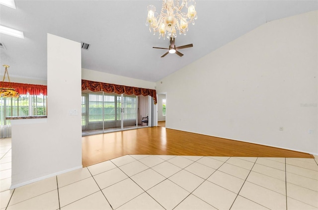 9519 Scenic Pine Ct, New Port Richey, FL 34655 - unfurnished room featuring vaulted ceiling, a chandelier, light tile patterned floors, ceiling fan, and healthy amount of natural light