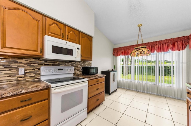9519 Scenic Pine Ct, New Port Richey, FL 34655 - kitchen featuring white appliances, vaulted ceiling, dark countertops, decorative backsplash, and brown cabinets
