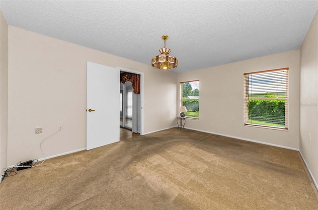 9519 Scenic Pine Ct, New Port Richey, FL 34655 - carpeted empty room with a chandelier and a textured ceiling