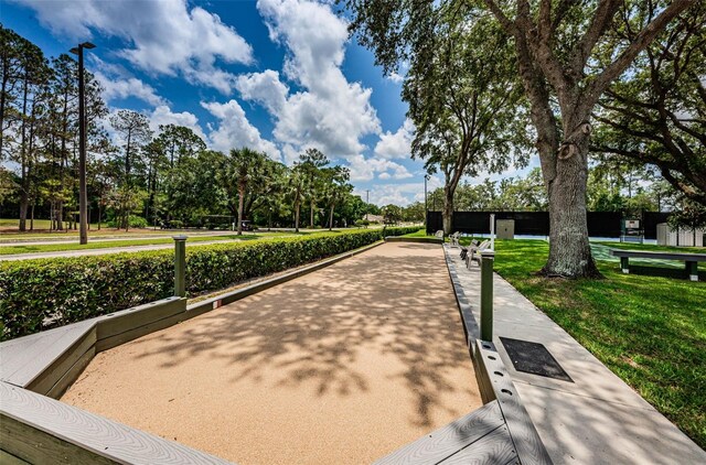 9519 Scenic Pine Ct, New Port Richey, FL 34655 - view of property's community with a game area, a lawn, and view of wooded area