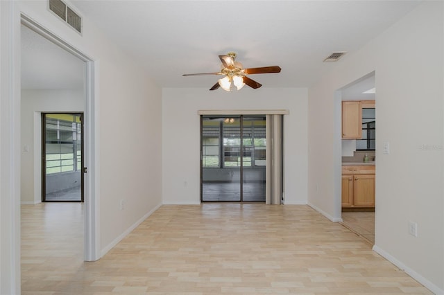 11127 Water Oak Dr, Port Richey, FL 34668 - unfurnished room featuring light wood-style floors, plenty of natural light, and ceiling fan
