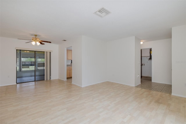 11127 Water Oak Dr, Port Richey, FL 34668 - empty room featuring ceiling fan and light wood-type flooring