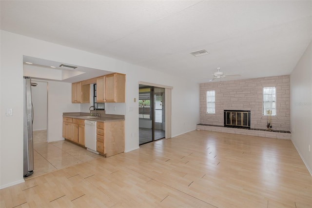 11127 Water Oak Dr, Port Richey, FL 34668 - kitchen with a ceiling fan, light brown cabinetry, dishwasher, light wood-style flooring, and freestanding refrigerator