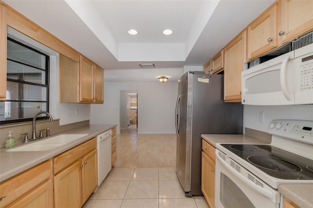 11127 Water Oak Dr, Port Richey, FL 34668 - kitchen with white appliances, light tile patterned flooring, light brown cabinetry, light countertops, and a raised ceiling