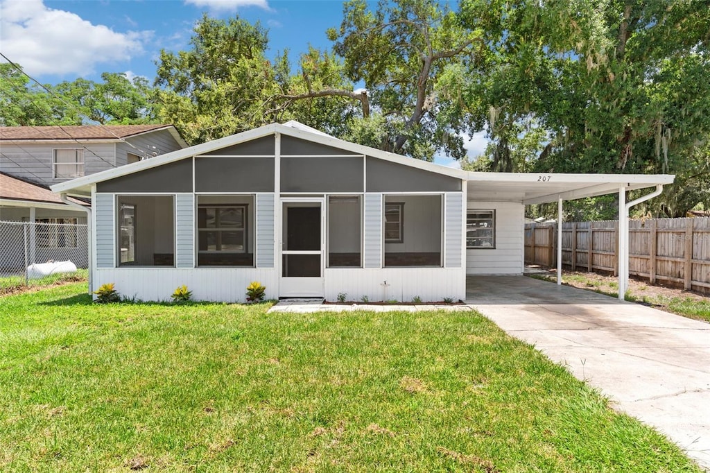 207 Dixie Hwy, Auburndale, FL 33823 - view of front of home with driveway and an attached carport