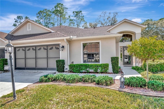 9626 Woodhollow Ct, New Port Richey, FL 34655 - ranch-style house with stucco siding, a garage, driveway, a shingled roof, and a front yard