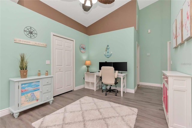 9626 Woodhollow Ct, New Port Richey, FL 34655 - home office featuring light wood-type flooring, ceiling fan, and high vaulted ceiling