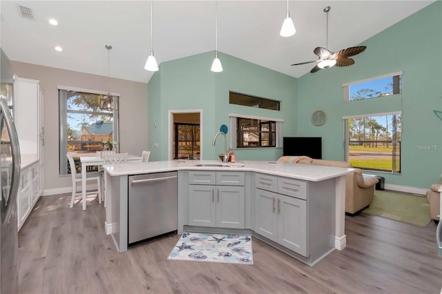 9626 Woodhollow Ct, New Port Richey, FL 34655 - kitchen with appliances with stainless steel finishes, open floor plan, high vaulted ceiling, light countertops, and plenty of natural light