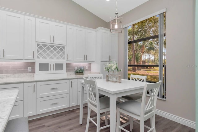 9626 Woodhollow Ct, New Port Richey, FL 34655 - dining room featuring lofted ceiling and wood finished floors