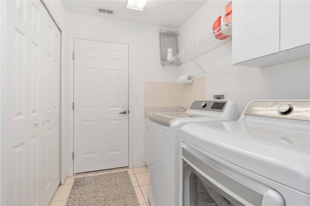 9626 Woodhollow Ct, New Port Richey, FL 34655 - washroom with cabinet space, separate washer and dryer, and light tile patterned floors