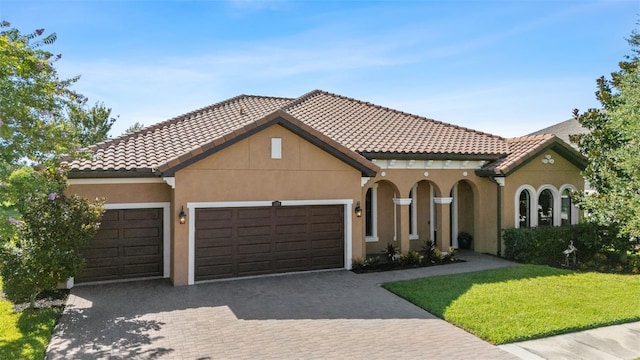 13208 Fawn Lily Dr, Riverview, FL 33579 - mediterranean / spanish-style house featuring decorative driveway, an attached garage, a front yard, a tiled roof, and stucco siding