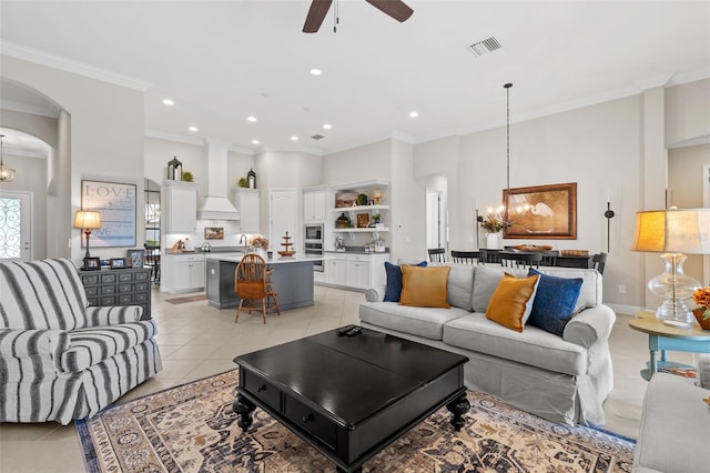 13208 Fawn Lily Dr, Riverview, FL 33579 - living area featuring crown molding, light tile patterned flooring, a chandelier, ceiling fan, and arched walkways