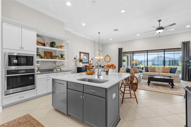 13208 Fawn Lily Dr, Riverview, FL 33579 - kitchen with appliances with stainless steel finishes, gray cabinetry, white cabinetry, light tile patterned floors, and crown molding