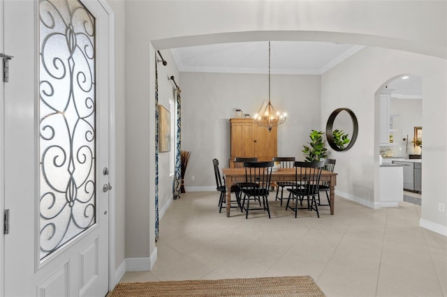 13208 Fawn Lily Dr, Riverview, FL 33579 - dining area featuring ornamental molding, arched walkways, a chandelier, and light tile patterned flooring