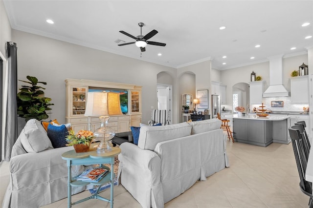 13208 Fawn Lily Dr, Riverview, FL 33579 - living area with arched walkways, ceiling fan, recessed lighting, light tile patterned floors, and ornamental molding