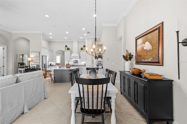 13208 Fawn Lily Dr, Riverview, FL 33579 - dining area with ornamental molding, a chandelier, light tile patterned flooring, recessed lighting, and arched walkways