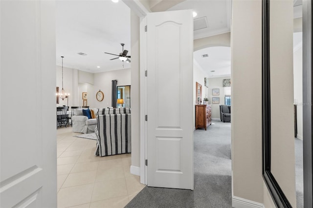 13208 Fawn Lily Dr, Riverview, FL 33579 - hall featuring arched walkways, ornamental molding, light tile patterned flooring, a chandelier, and recessed lighting