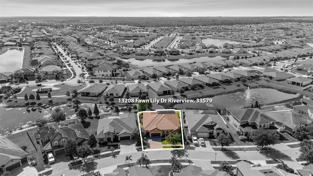 13208 Fawn Lily Dr, Riverview, FL 33579 - aerial view of residential area with property boundaries highlighted and a large body of water