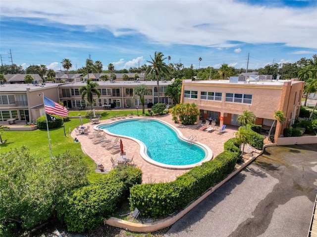 225 Country Club Dr Unit A203, Largo, FL 33771 - community pool featuring a patio area and a yard