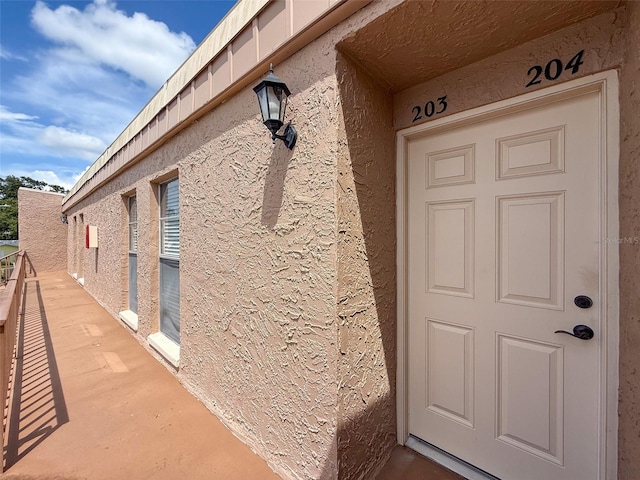 225 Country Club Dr Unit A203, Largo, FL 33771 - view of exterior entry with stucco siding