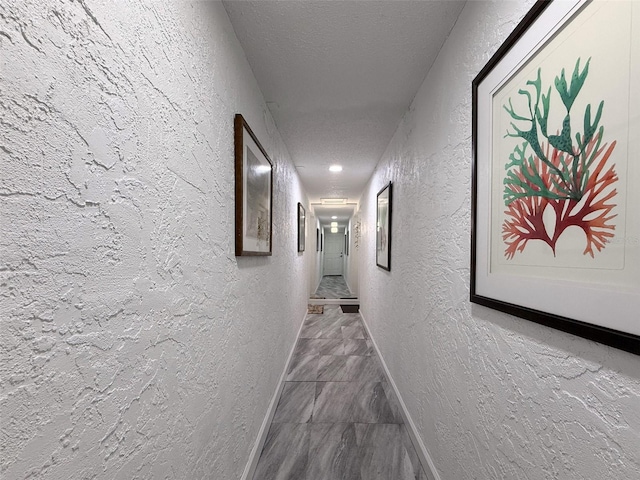 225 Country Club Dr Unit A203, Largo, FL 33771 - corridor featuring a textured wall, marble finish flooring, and a textured ceiling