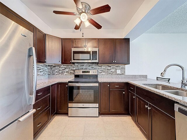 225 Country Club Dr Unit A203, Largo, FL 33771 - kitchen featuring appliances with stainless steel finishes, a ceiling fan, tasteful backsplash, and dark brown cabinets