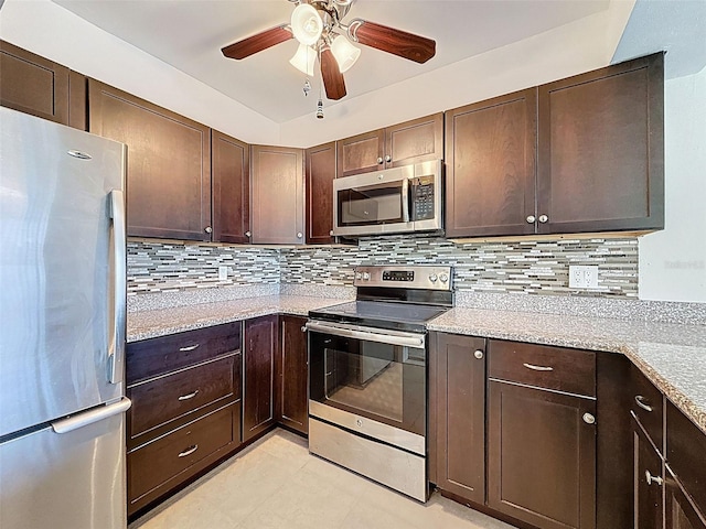 225 Country Club Dr Unit A203, Largo, FL 33771 - kitchen with appliances with stainless steel finishes, a ceiling fan, dark brown cabinets, and tasteful backsplash