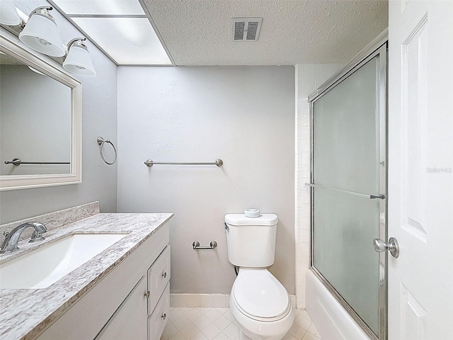 225 Country Club Dr Unit A203, Largo, FL 33771 - bathroom featuring vanity, tile patterned flooring, enclosed tub / shower combo, and a textured ceiling
