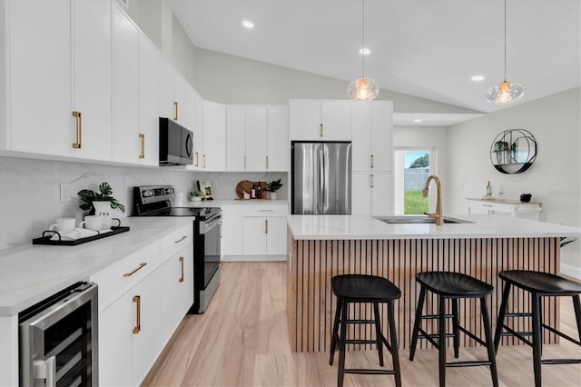 6529 Taylor Ct, New Port Richey, FL 34653 - kitchen with appliances with stainless steel finishes, beverage cooler, a breakfast bar, lofted ceiling, and tasteful backsplash