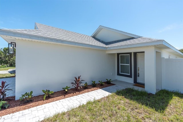 6529 Taylor Ct, New Port Richey, FL 34653 - view of front facade featuring roof with shingles and stucco siding