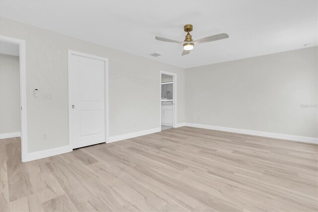 6529 Taylor Ct, New Port Richey, FL 34653 - unfurnished bedroom featuring light wood-type flooring, a closet, a ceiling fan, and ensuite bath