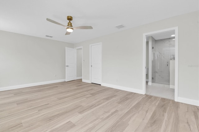 6529 Taylor Ct, New Port Richey, FL 34653 - unfurnished bedroom featuring light wood-style flooring, ensuite bath, and a ceiling fan