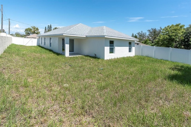 6529 Taylor Ct, New Port Richey, FL 34653 - back of house with a fenced backyard and stucco siding