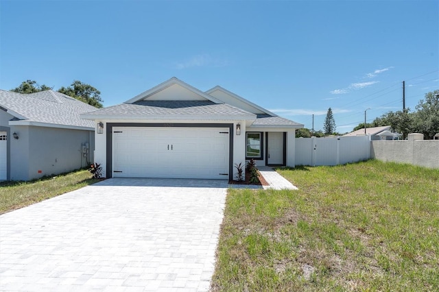 6529 Taylor Ct, New Port Richey, FL 34653 - single story home featuring an attached garage, decorative driveway, a shingled roof, and stucco siding