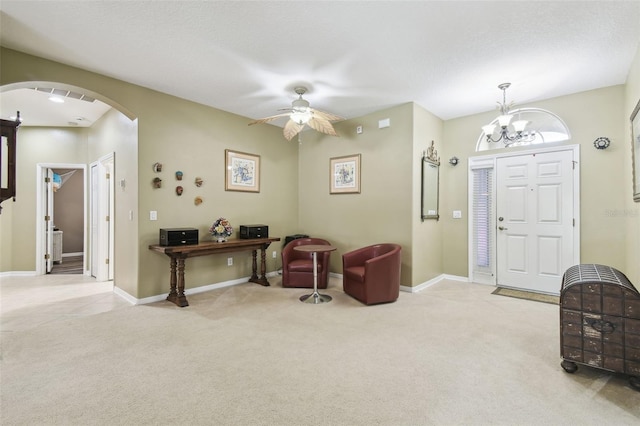 11126 Biddeford Pl, New Port Richey, FL 34654 - foyer with arched walkways, carpet, ceiling fan, and a chandelier
