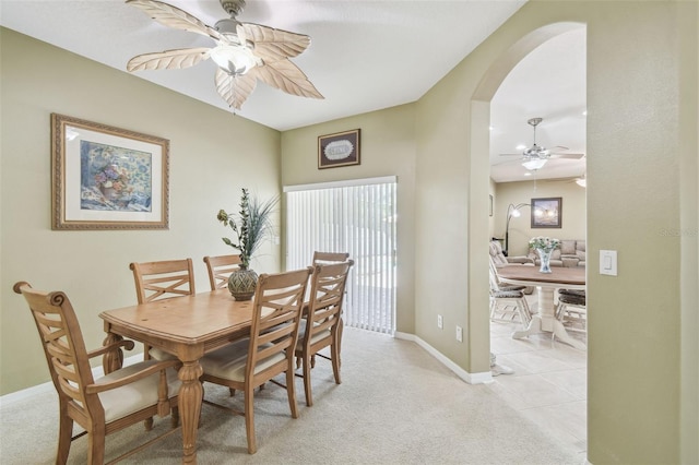 11126 Biddeford Pl, New Port Richey, FL 34654 - dining area featuring arched walkways, a ceiling fan, and light carpet