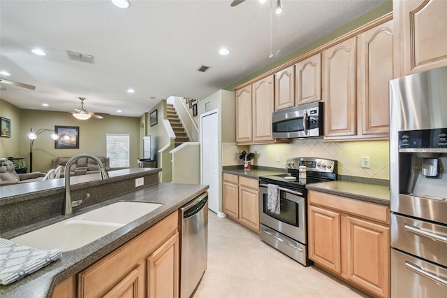 11126 Biddeford Pl, New Port Richey, FL 34654 - kitchen featuring appliances with stainless steel finishes, ceiling fan, open floor plan, decorative backsplash, and recessed lighting