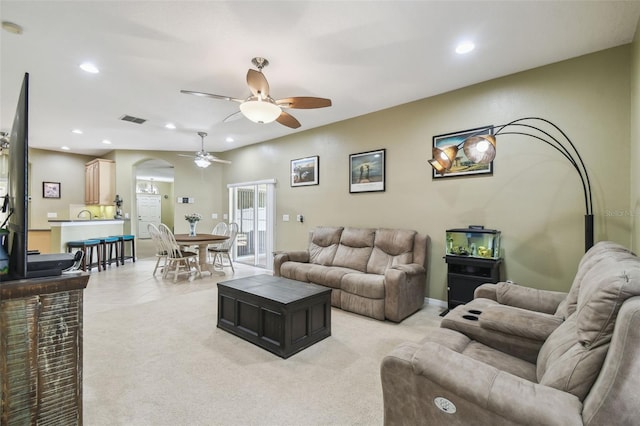 11126 Biddeford Pl, New Port Richey, FL 34654 - living area featuring ceiling fan, arched walkways, recessed lighting, and light colored carpet