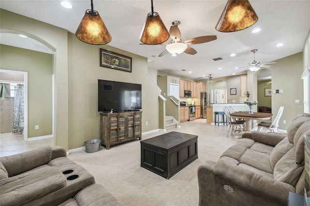 11126 Biddeford Pl, New Port Richey, FL 34654 - living room featuring arched walkways, a ceiling fan, light carpet, recessed lighting, and stairs