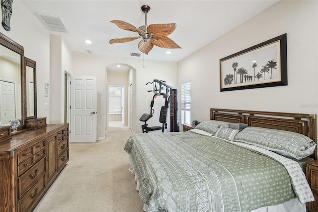 11126 Biddeford Pl, New Port Richey, FL 34654 - bedroom with arched walkways, light colored carpet, recessed lighting, ceiling fan, and ensuite bathroom