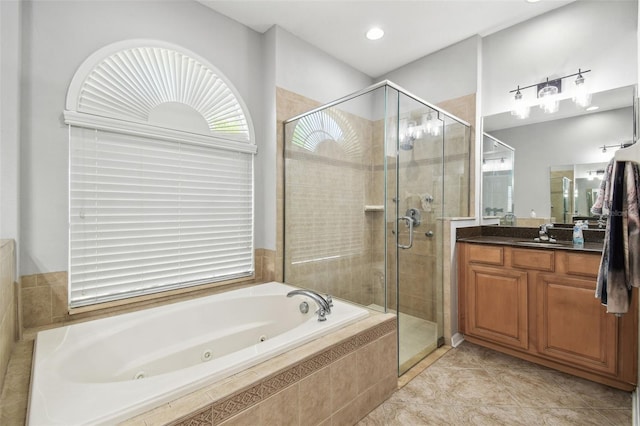 11126 Biddeford Pl, New Port Richey, FL 34654 - bathroom featuring a jetted tub, vanity, a stall shower, and tile patterned flooring