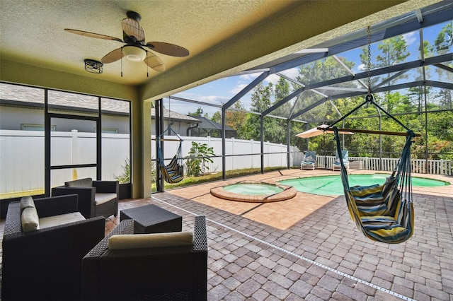 11126 Biddeford Pl, New Port Richey, FL 34654 - fenced backyard featuring a patio area, ceiling fan, a pool with connected hot tub, glass enclosure, and an outdoor living space