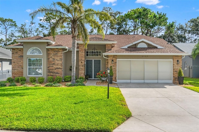 single story home with a front yard, stucco siding, driveway, and an attached garage