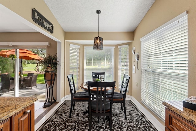 dining room featuring light tile patterned floors and a textured ceiling