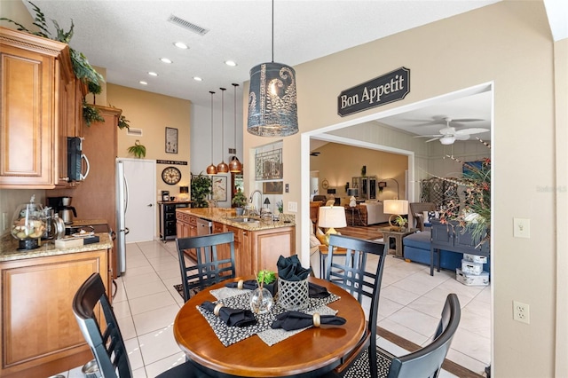 dining space with light tile patterned flooring, a ceiling fan, and recessed lighting