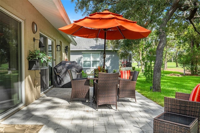 view of patio featuring a grill and outdoor dining space