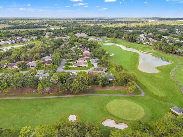 view of property location featuring nearby suburban area, a large body of water, and a local golf course