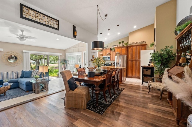dining space featuring light wood finished floors, ceiling fan, recessed lighting, and high vaulted ceiling